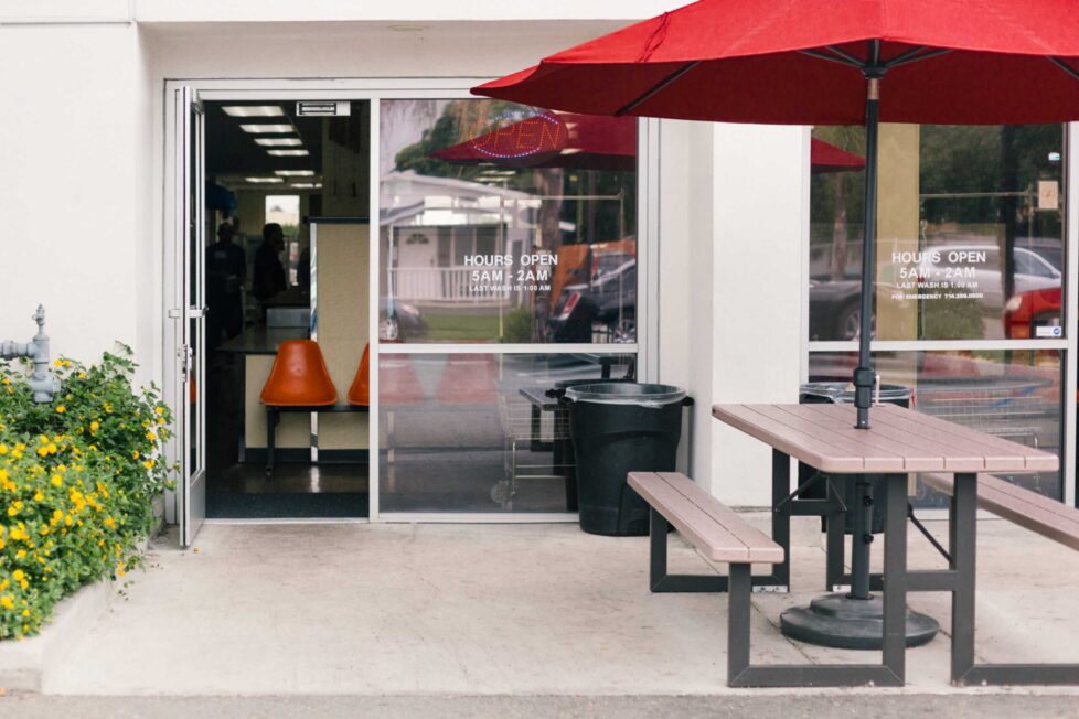A red umbrella is hanging over the patio.