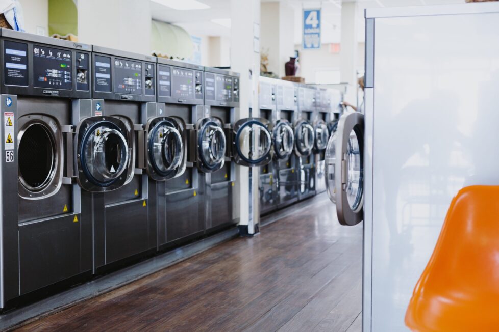 A row of washing machines in a room.